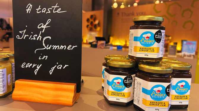 A small selection of Rhubarb and Ginger Jam by Annie's Delights, beside a chalkboard sign stating, 'A taste of Irish summer in every jar' in the Retail area of the Giant's Causeway Visitor Centre